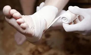 Doctor doing a bandage for patient